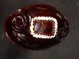 a brown bowl with a brown and white design on it