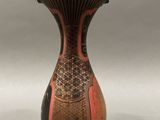an image of a vase with a red and black design