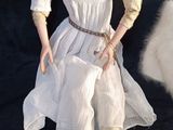 a doll that is sitting on a black surface