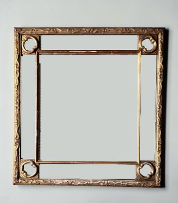 an image of a gold framed mirror on a white wall