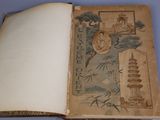 an old book that is open on a blue surface