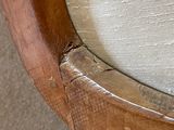 a close up of a chair with a wood frame