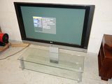 a flat screen tv sitting on top of a glass table