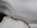 close up of a white porcelain statue of a man with a crown on his head