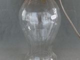 a glass lamp that is sitting on a table