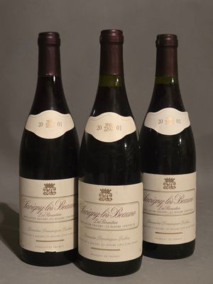 three bottles of wine sitting on top of a table next to each other