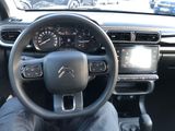 the interior of a car with a steering wheel and dashboard controls
