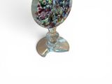 a glass vase with a bunch of flowers inside of it