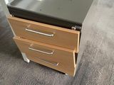 a desk with two drawers and a book on it