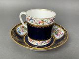 a close up of a cup and saucer on a table