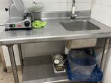 a kitchen with a sink and a mixer on the counter
