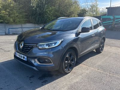a grey renault kad suv parked in a parking lot