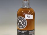 a bottle of whisky sitting on top of a white table