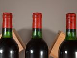 three bottles of wine sitting on a table next to each other