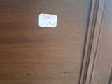 a wooden cabinet with a white sticker on it