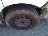 a white car that has a flat tire on it