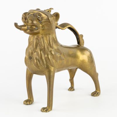 bronze figurine of a dog with a crown on it ' s head