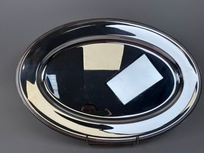 an image of a silver plate with a piece of paper sticking out of it