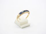 a close up of a gold ring with blue sapphires on it