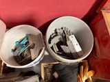 two buckets with tools in them sitting on the floor