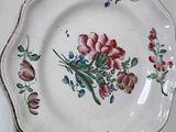 a plate with flowers on it sitting on a table