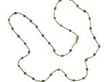 un long collier de perles vertes avec une chaîne dorée sur fond blanc
