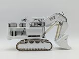 a toy excavator that is sitting on a white surface