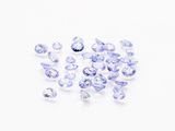 a bunch of blue sapphires on a white surface