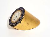 a clock that is sitting on top of a gold cone