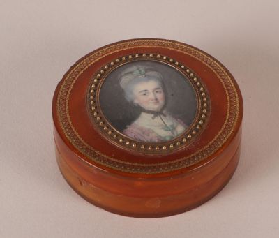 a small wooden box with a picture of a woman on it