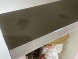 a doll that is sitting inside of a box