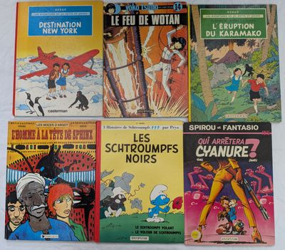 Plusieurs bandes dessinées sont alignées sur une surface blanche