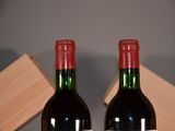 two bottles of wine sitting next to each other on a table