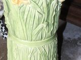 a vase with umbrellas in it sitting on the floor