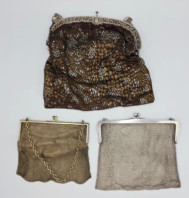 deux sacs à main et une chaîne de sac à main posés sur une surface blanche