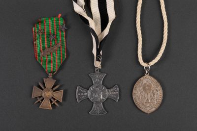 three medals and a medal on a black background