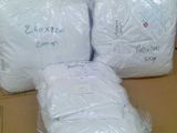 three rolls of toilet paper are wrapped in plastic bags on a cardboard box