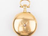 an image of a gold pocket watch with a diamond in the center