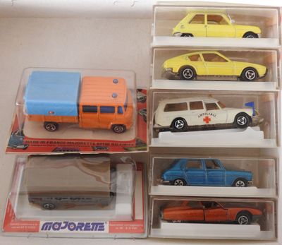 six toy cars in a display case on a table