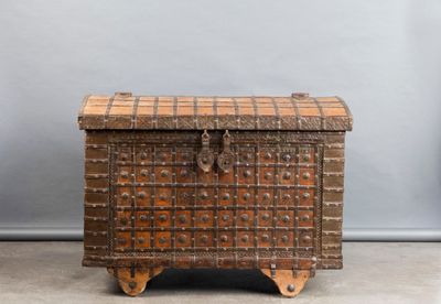 an old wooden chest with a checkered pattern on the top