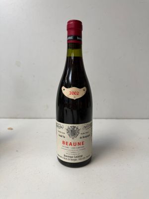 two bottles of wine sitting on a table next to each other