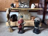 two figurines that are on a shelf in a room