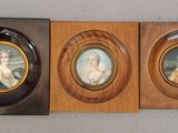 two framed pictures of a woman and a man in a wood frame