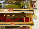 four toy buses stacked on top of each other