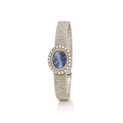 a lady ' s wrist watch with a blue dial and diamonds