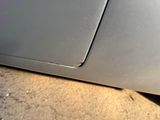 a close up of a car door with a hole in it