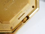 an image of a close up of a gold watch on a white surface