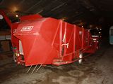 a red grainer that is parked in a garage
