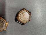 two watches that are sitting on a table