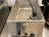 stainless steel counter top with two deep fryers and a coffee maker